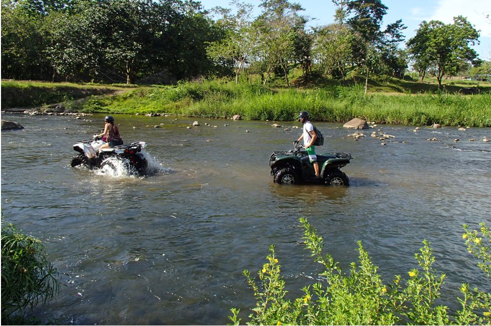 ATVs driving in river