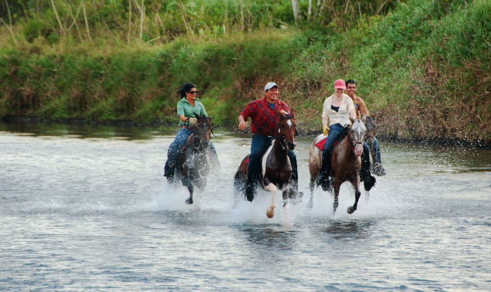 4 great riders racing through river in LaFinca 